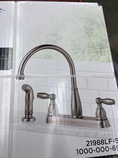 A picture of a kitchen sink faucet in a box