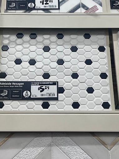 A display of black and white hexagon tiles on a shelf.