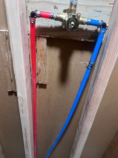 A close up of a plumbing pipe in a wall.