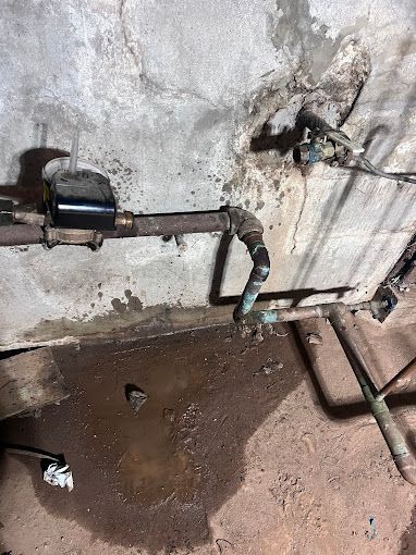 A close up of a water meter in a basement.