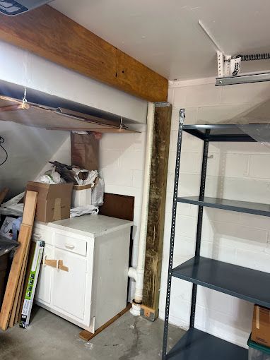 There is a washer and dryer in the corner of the room.