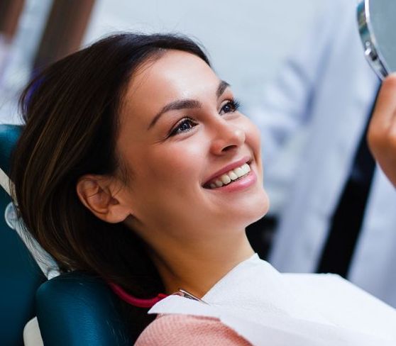 Smiling Patient Reclining in a Dental Chair During a Checkup — Smiles On Hobart in Sorell, TAS