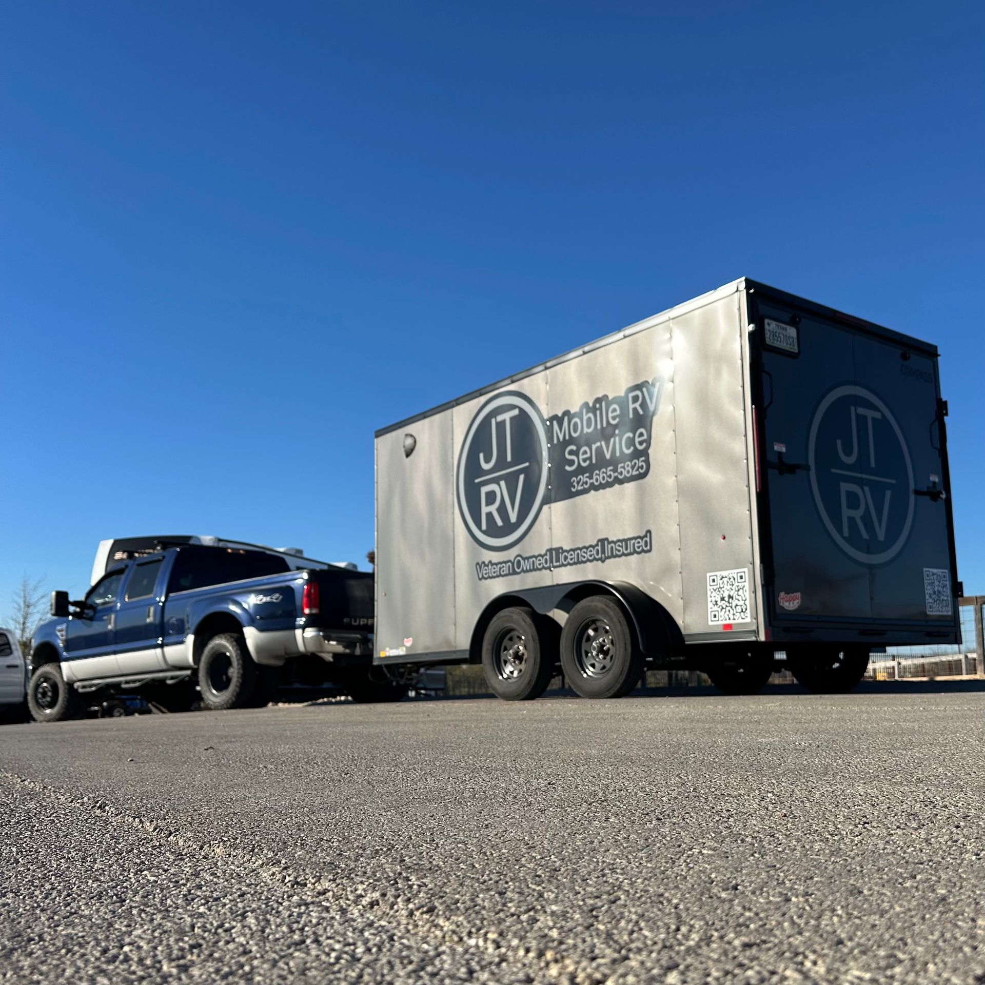 Blue truck towing a trailer with 
