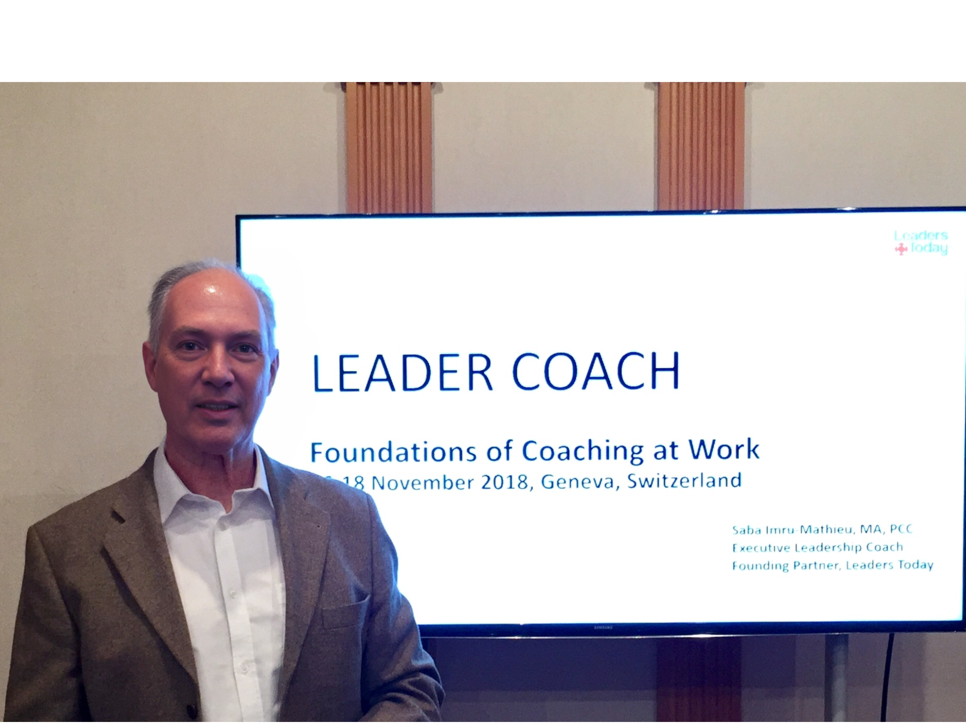 Man standing in front of a screen displaying