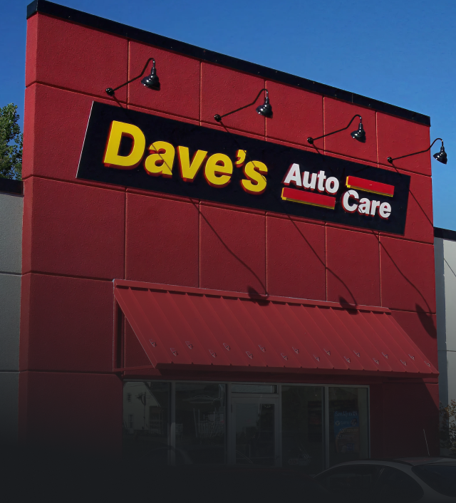 Exterior of Dave's Auto Care, red building with a sign and awning; Express Oil Shop next door. | Dave's Auto Care