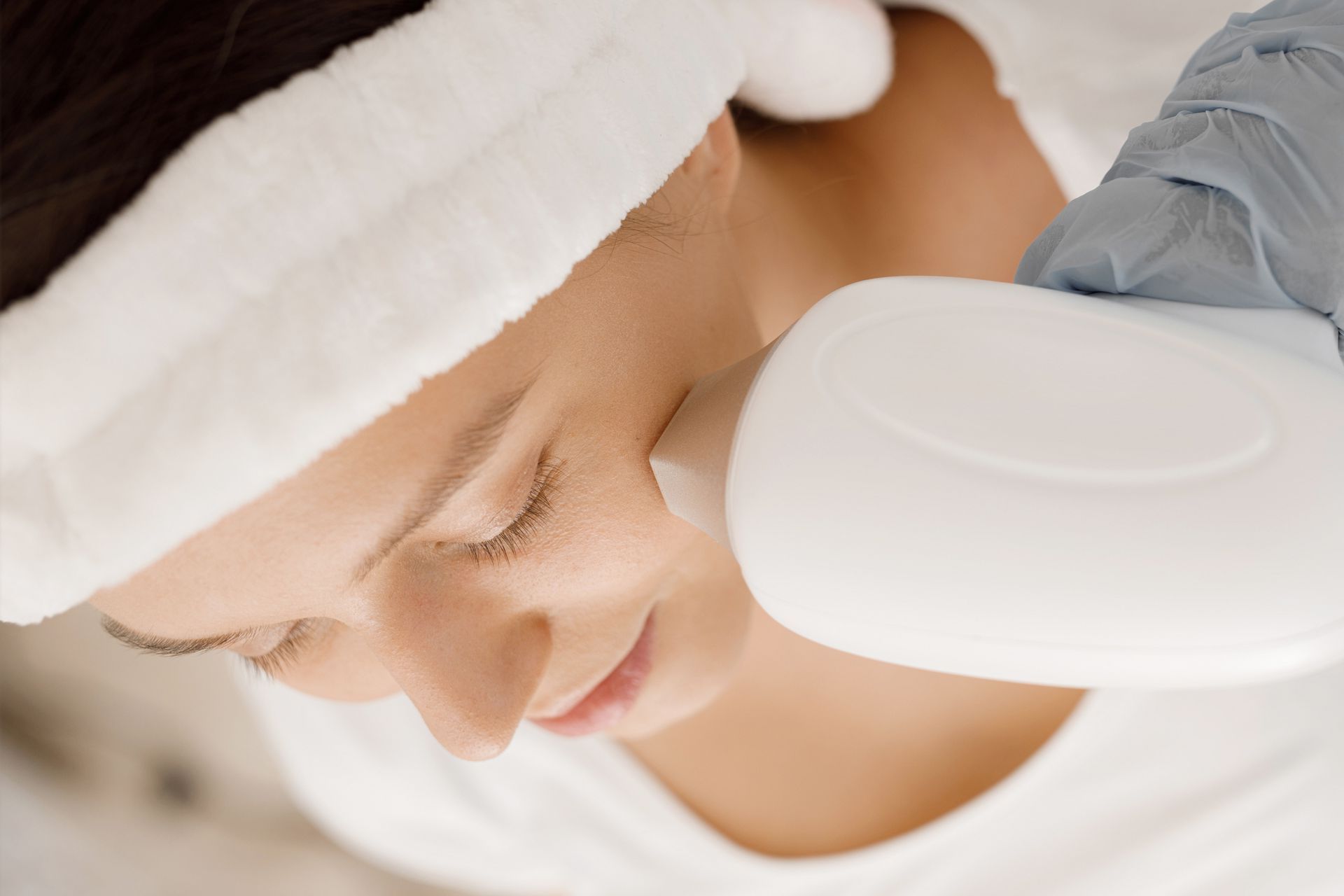 A woman is getting a laser treatment on her face.