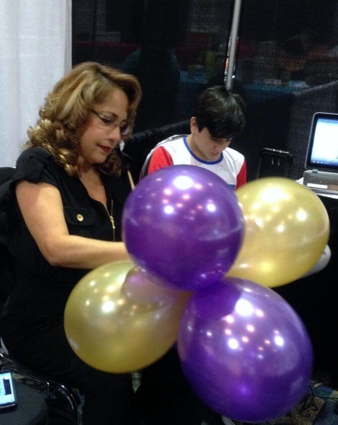 A Woman Holding A Balloon — Fort Myers, FL — Easy Tramites Corp