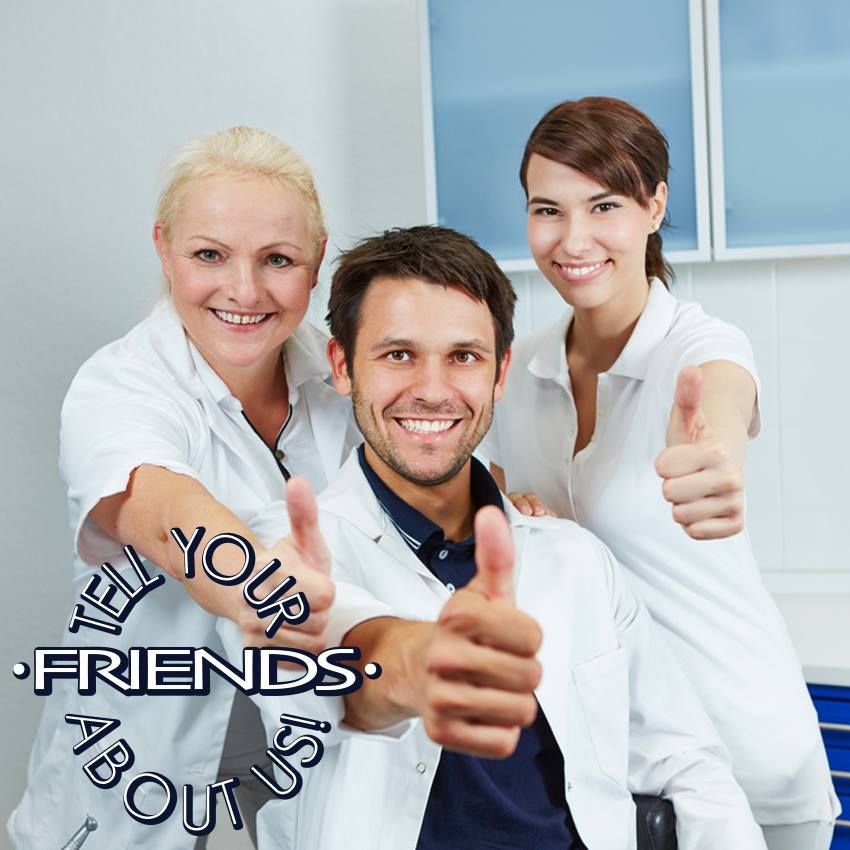 Three medical professionals smiling with thumbs up in an office setting.