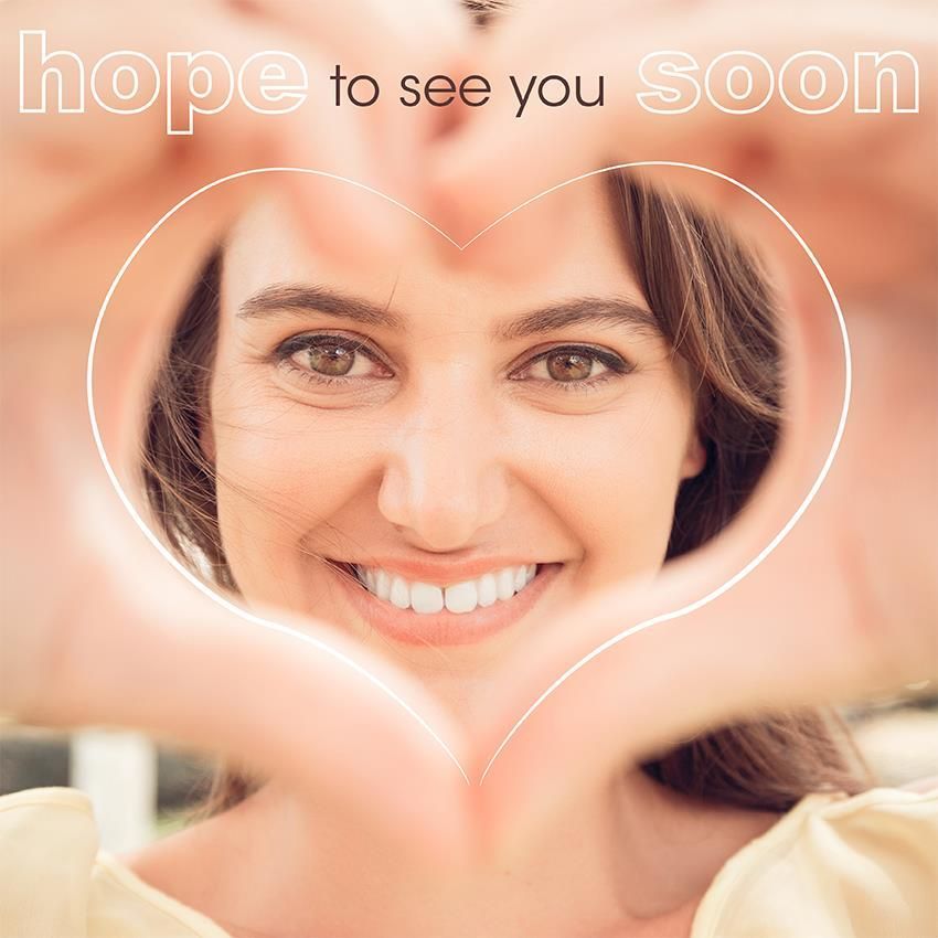 Woman smiling, hands forming a heart frame around her face, text hope to see you soon above.