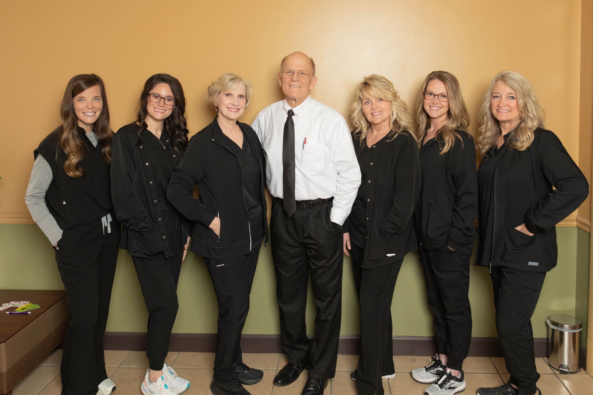 Smiling child with open mouth against a blue background, wearing a checkered shirt. Contact Us Today! text bubble.