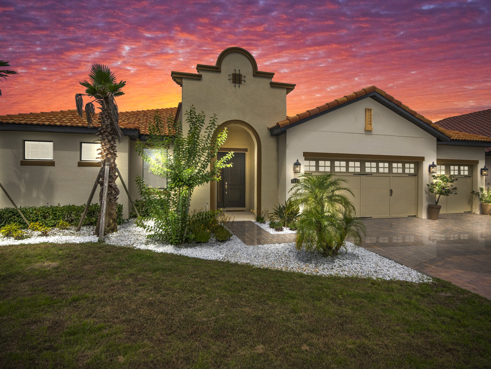The front of a house with a sunset in the background