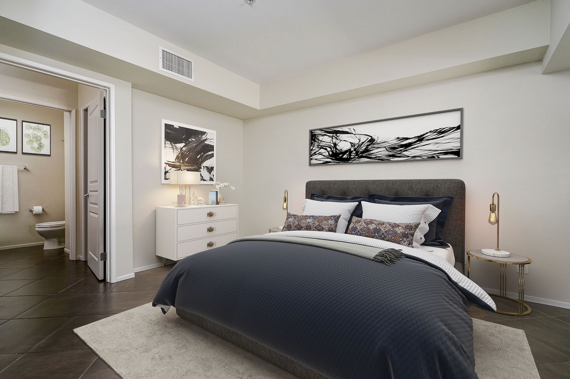 A bedroom with a large bed and a bathroom