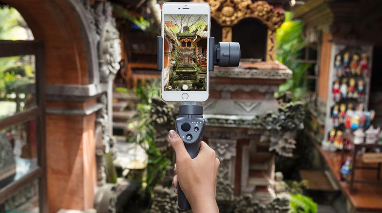 A person is holding a cell phone on a gimbal.