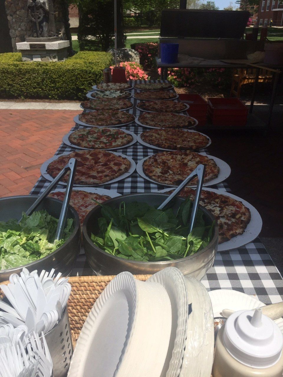 A table filled with lots of pizzas and salads