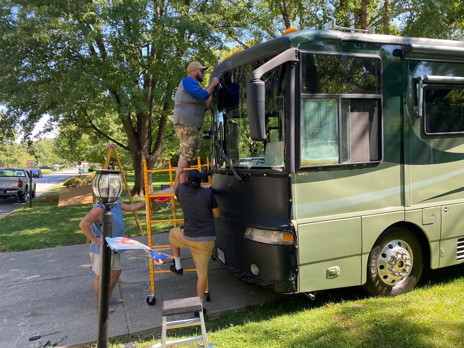 Man Fixing The Windshield Of A Bus — Indianapolis, IN — Rockstar Indy