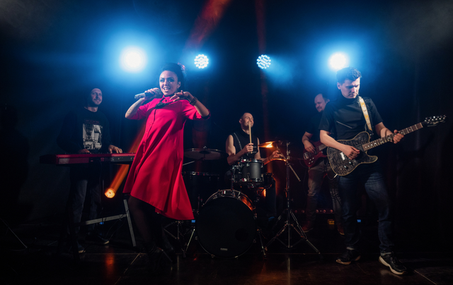 A group of people are playing instruments on a stage.