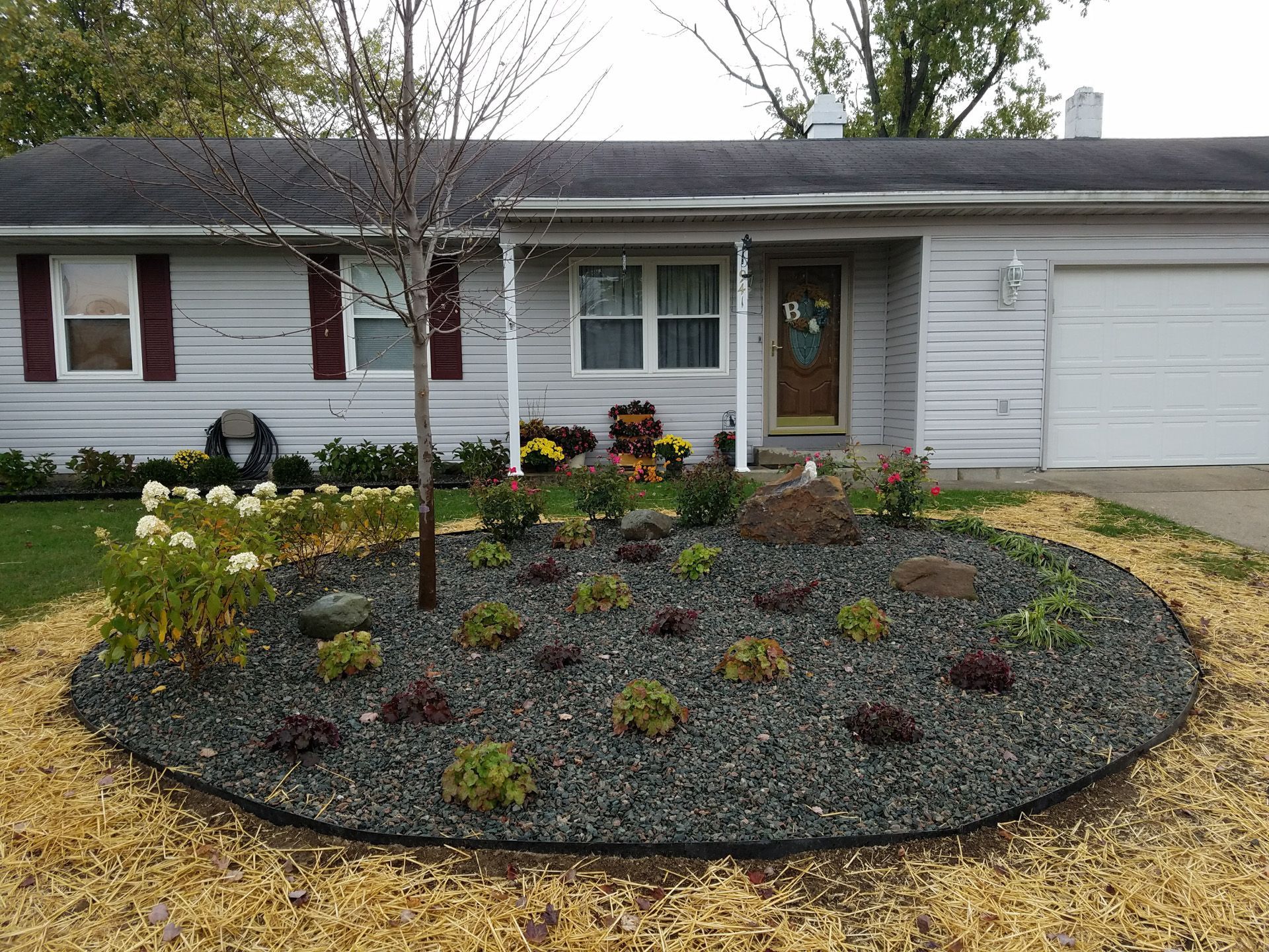 A house with a circular garden in front of it
