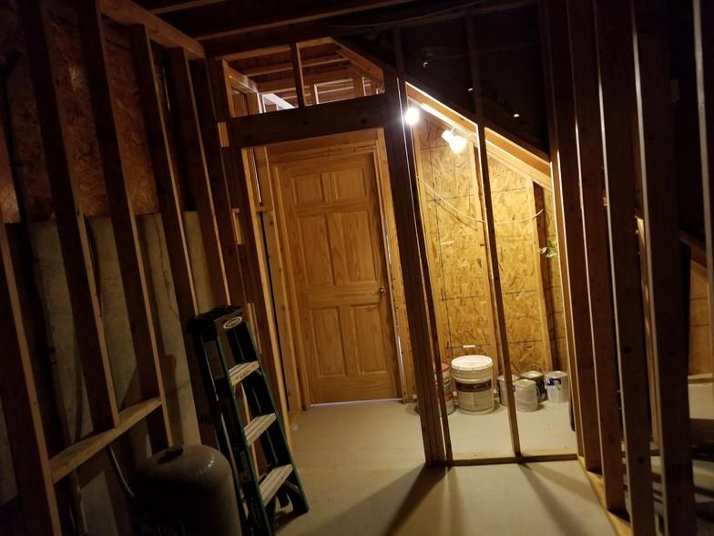 A room with a ladder and a toilet in it