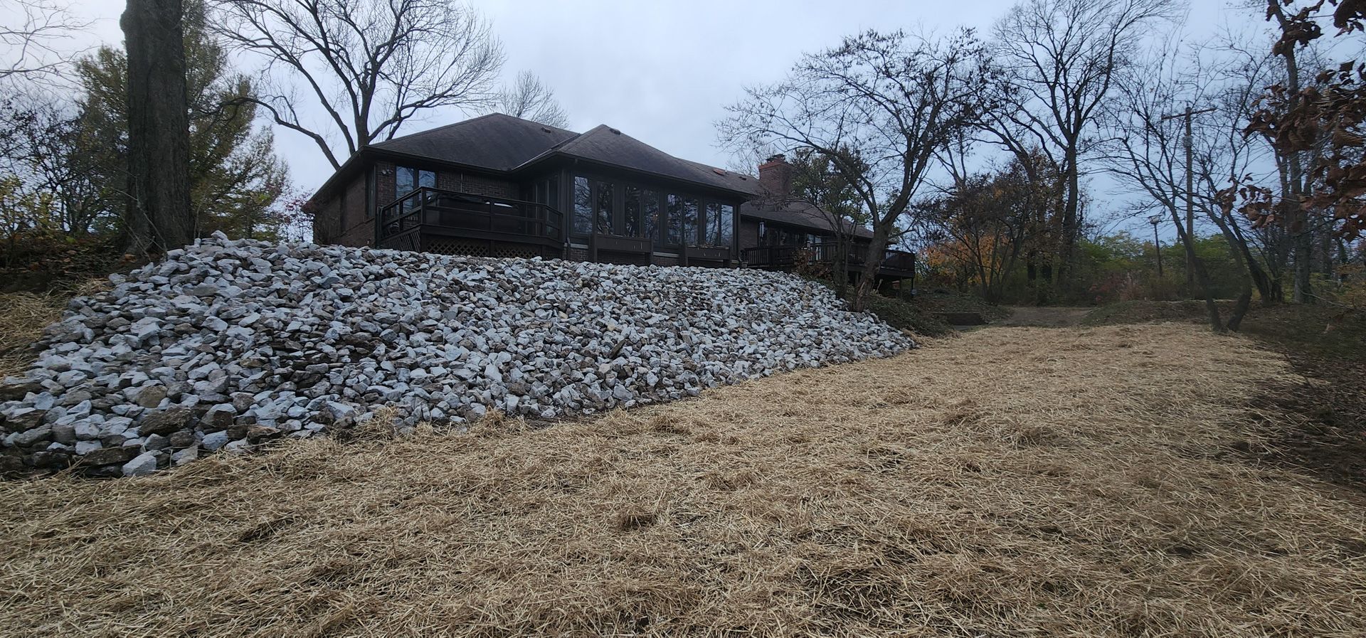 A house is sitting on top of a pile of rocks.
