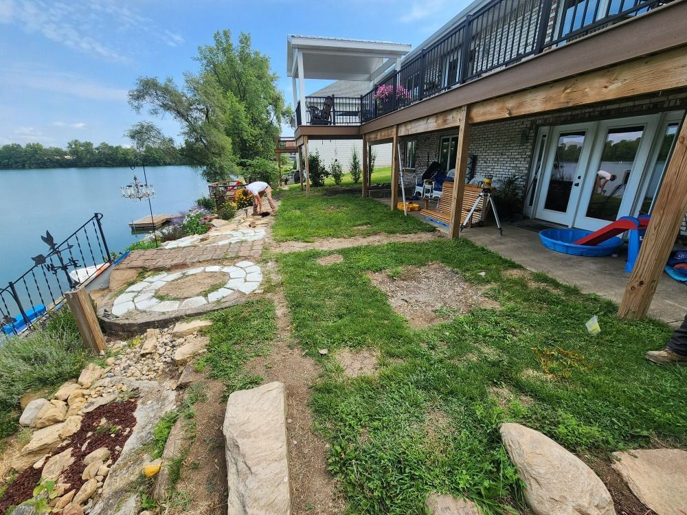 A house with a large deck overlooking a lake.