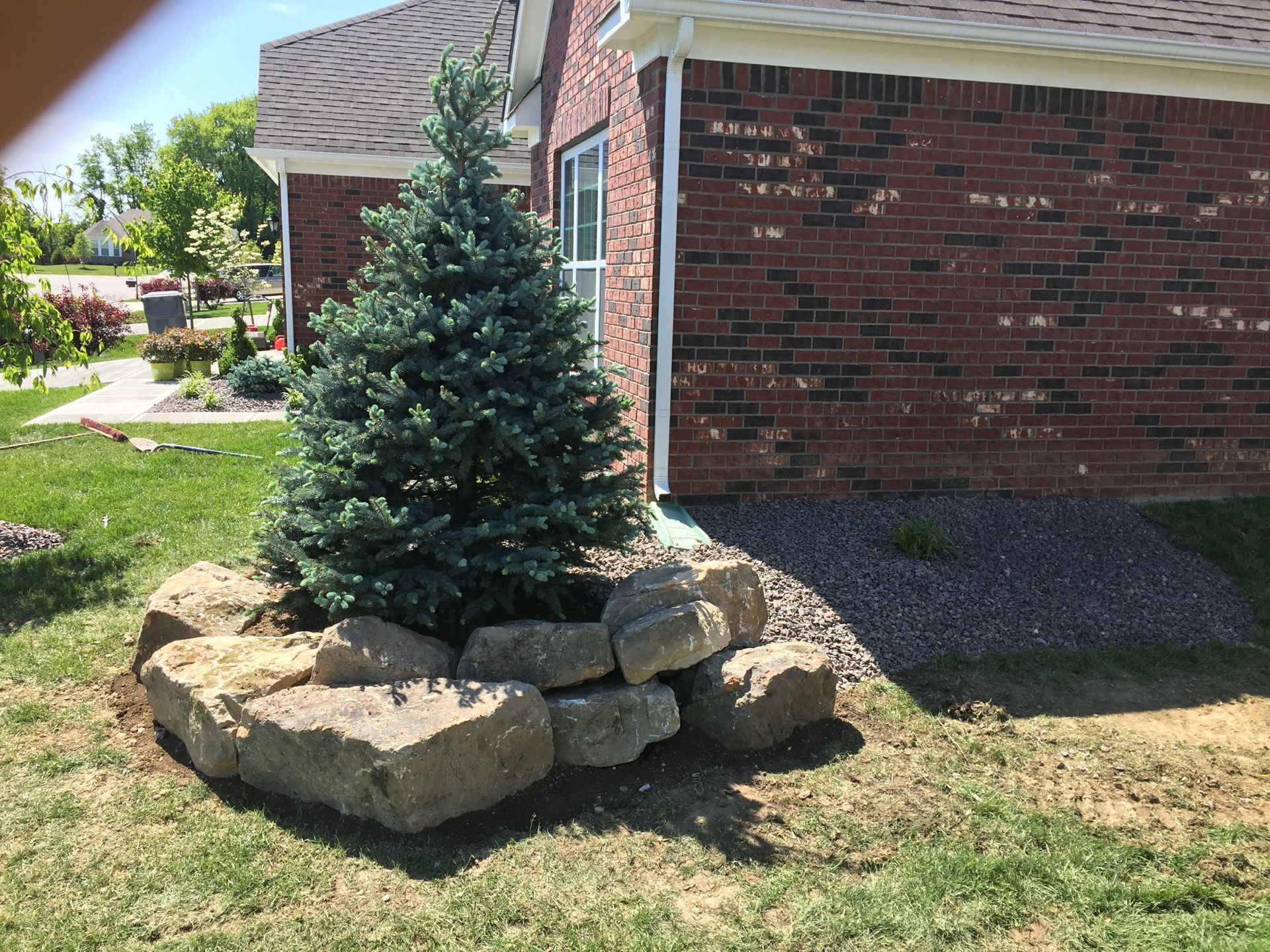 A brick house with a tree in front of it