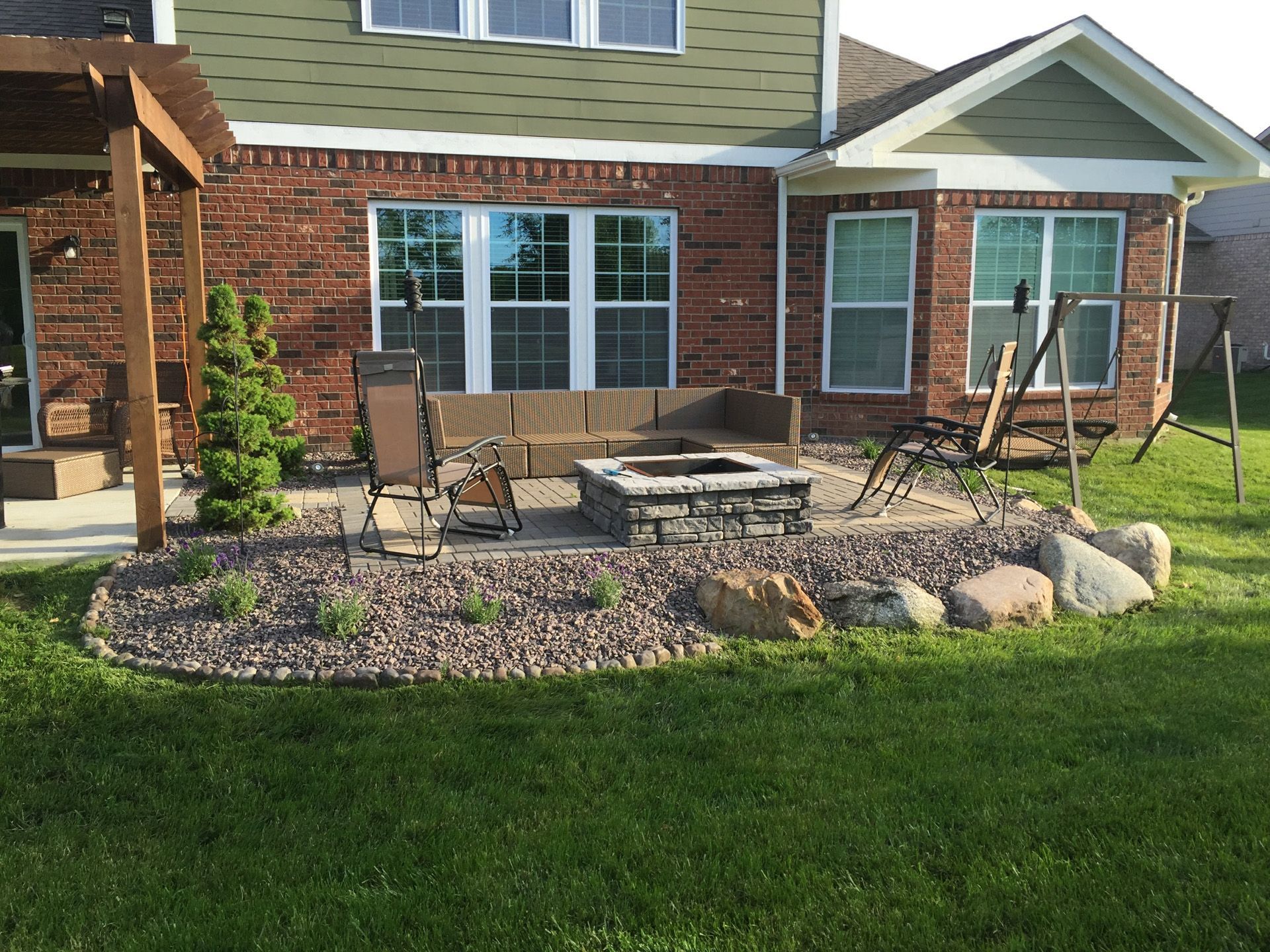 There is a fire pit in the backyard of a house.