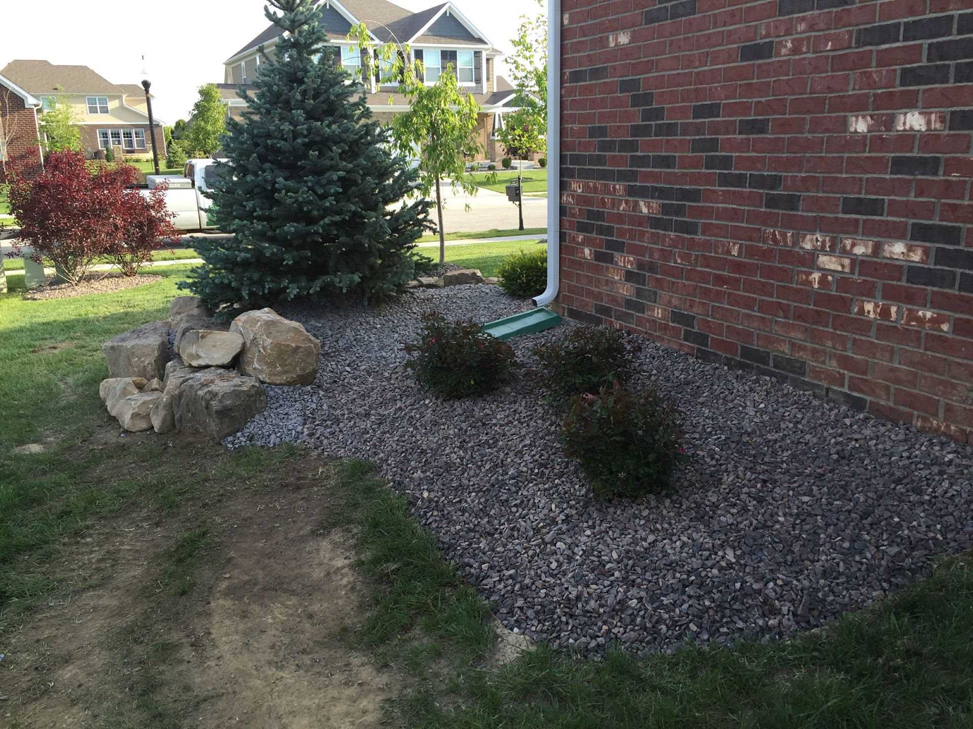 A brick house with a garden in front of it