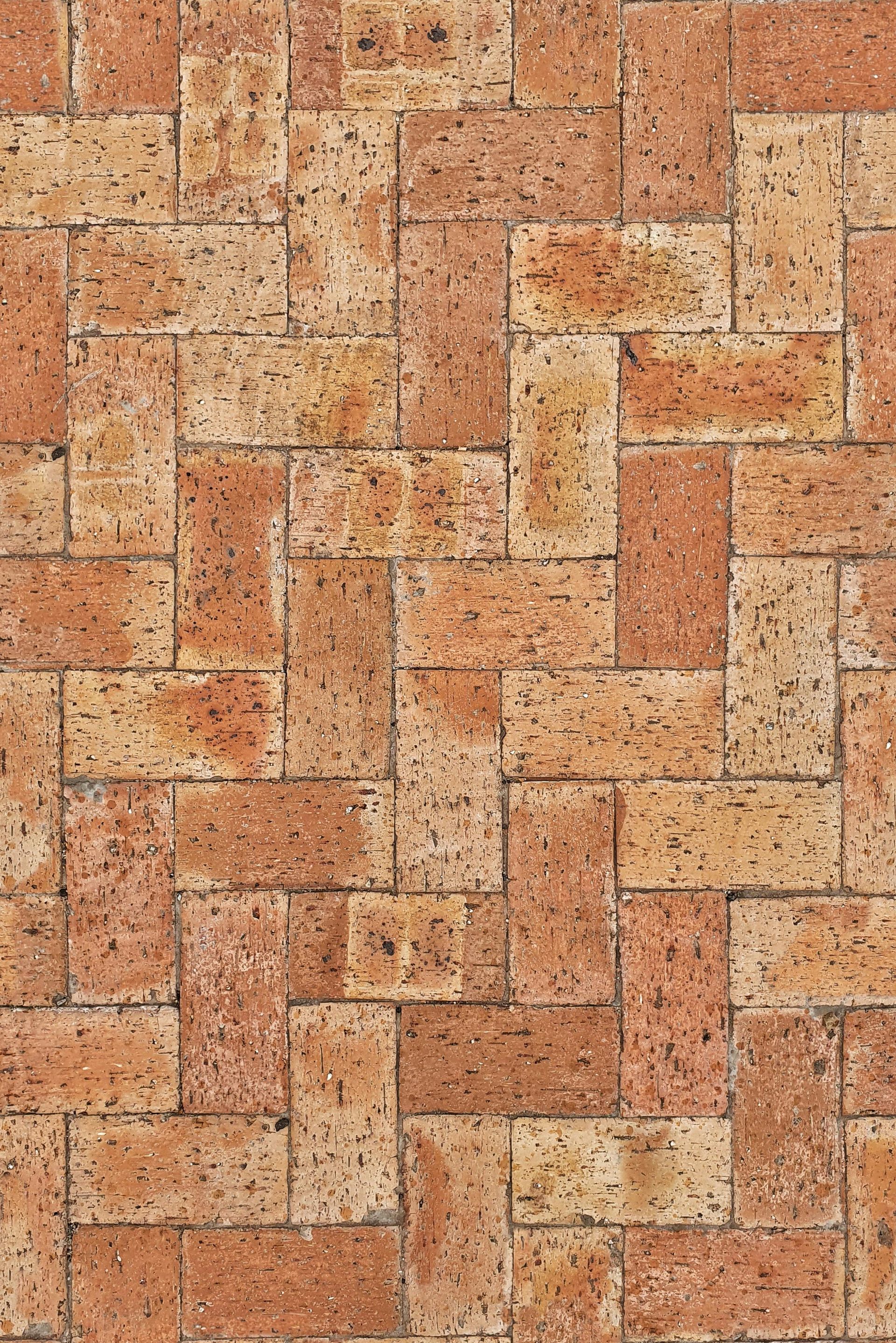 Herringbone brick pattern, alternating red and tan bricks.