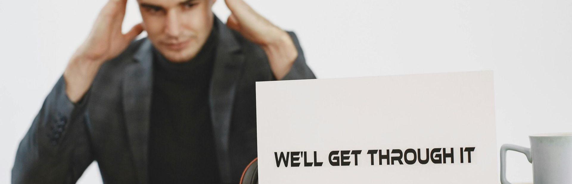 Scrunched up paper balls with a partially visible notepad on a textured surface.