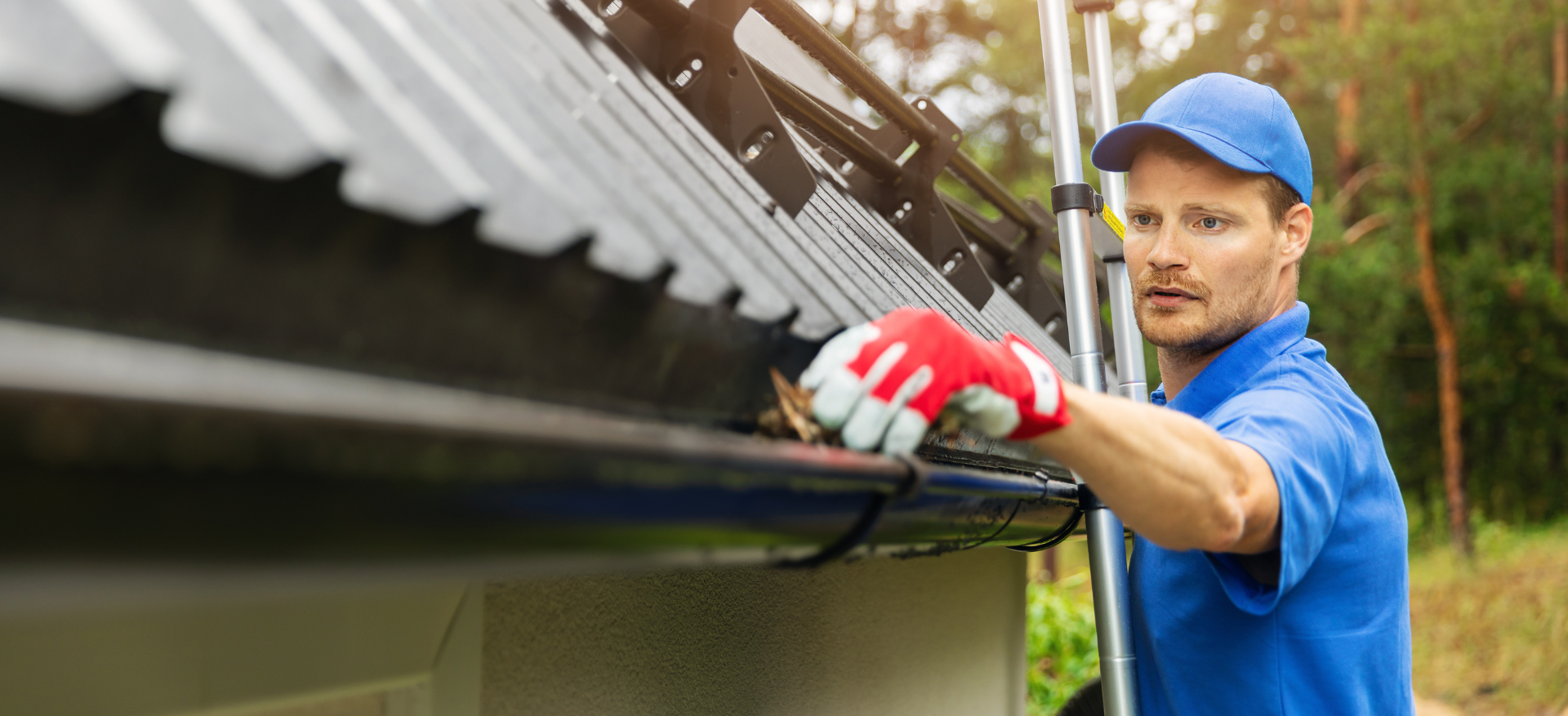 man cleaning a gutter