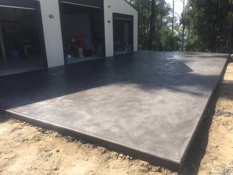 large square concrete area next to garage
