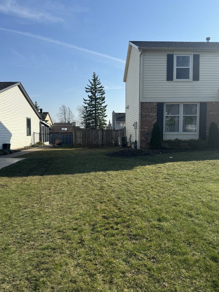 A house with a large lawn in front of it.