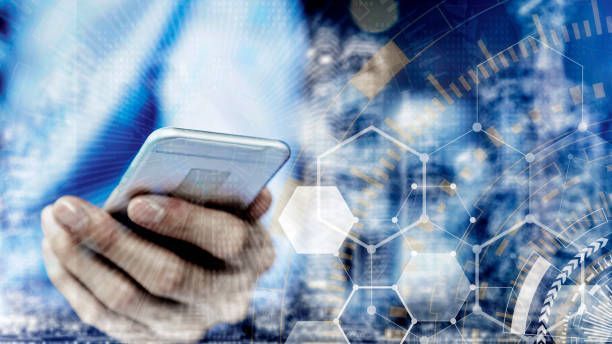 An aerial view of a large container ship passing under a bridge.