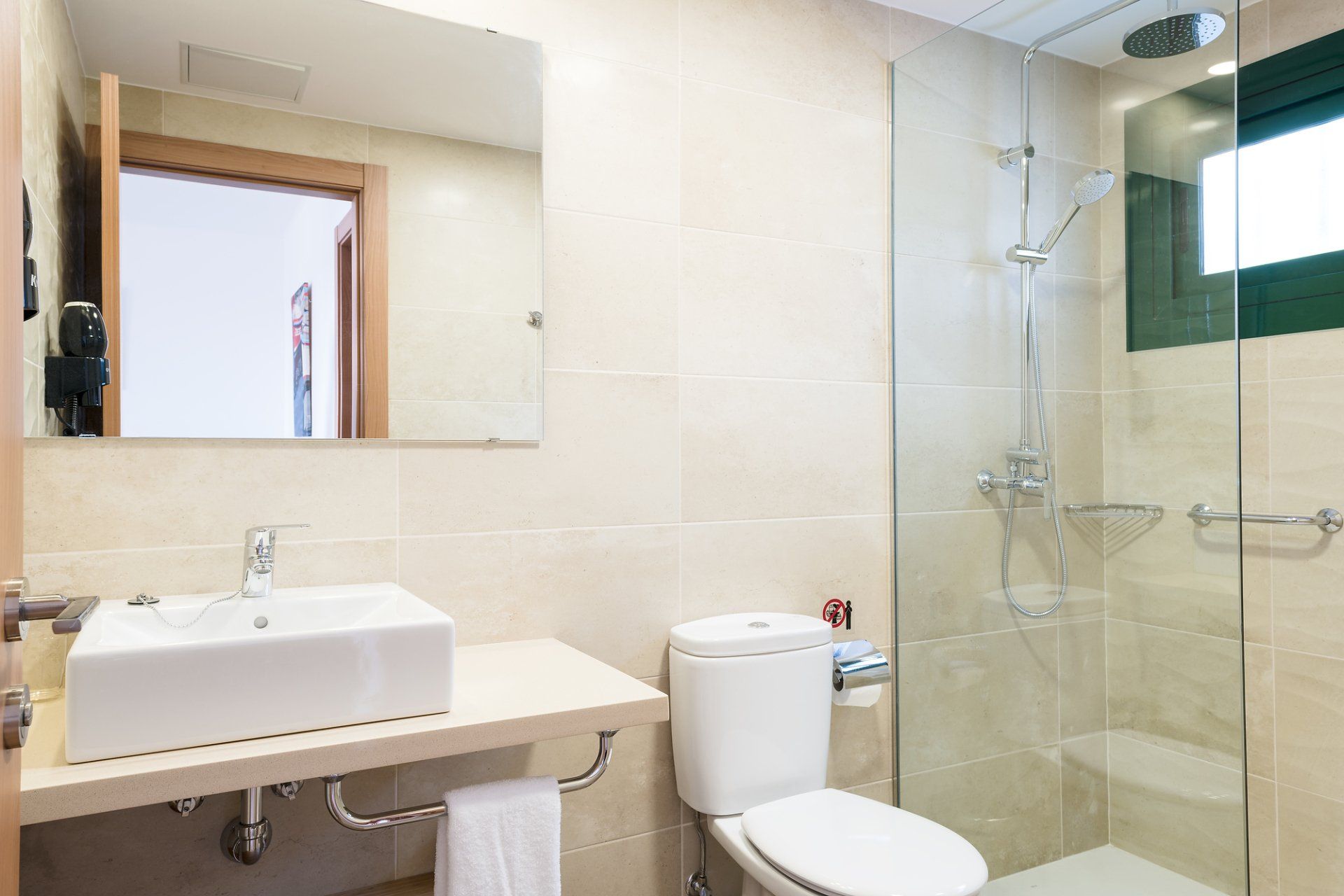 Bathroom with sink shelf, shower, and gel soap dispenser in the Villa Canaima Apartments