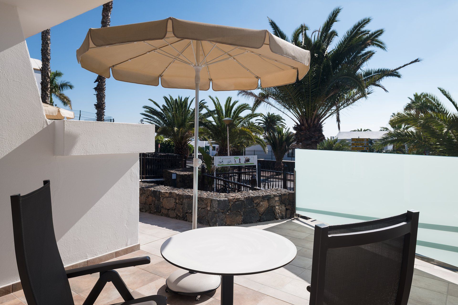 Terrace with table and chairs in the garden view apartment on the ground floor at Villa Canaima