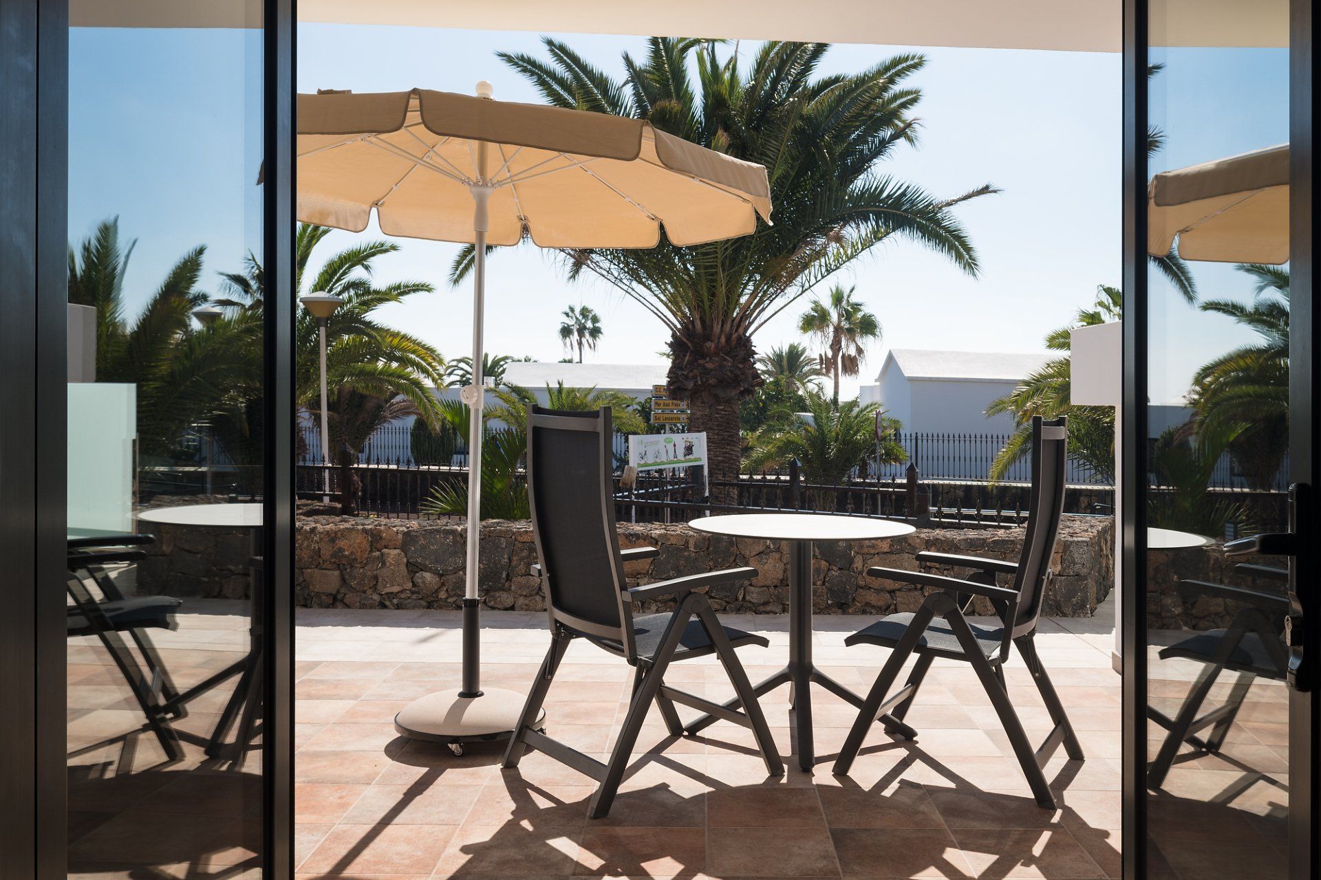 Terrace with table and chairs in the garden view apartment on the ground floor at Villa Canaima