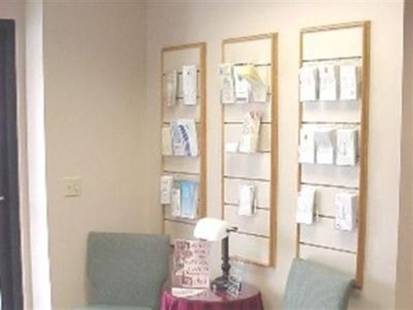 A waiting room with a chair and a table