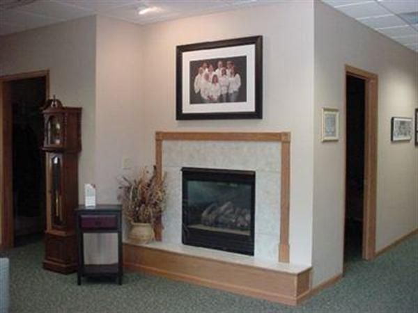 A living room with a fireplace and a clock