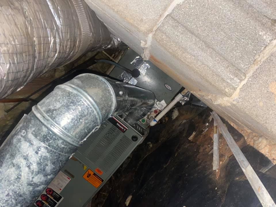 A picture of an air conditioner in a basement.