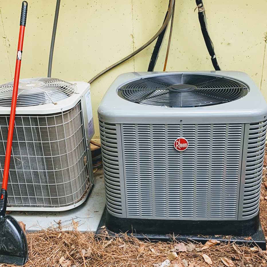 A hose is sitting in a flooded basement next to an air conditioner.