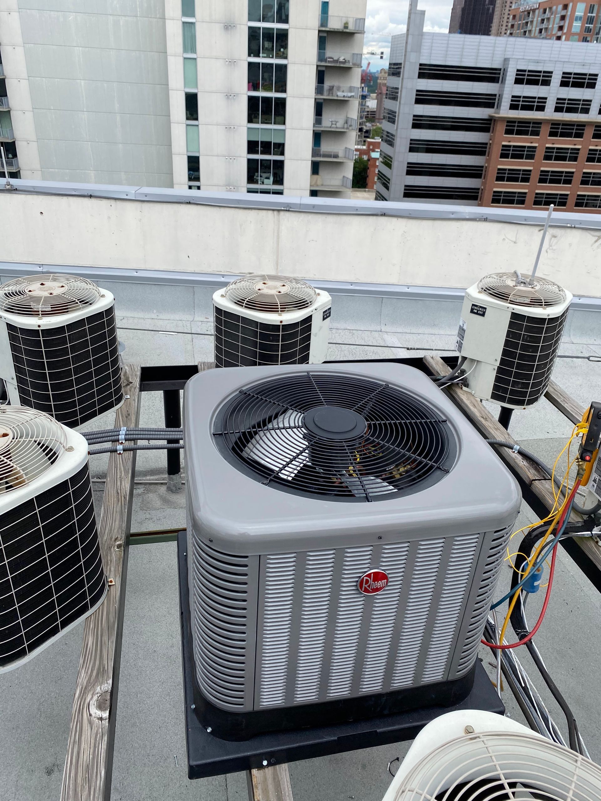 A large air conditioner is sitting on top of a wooden table.
