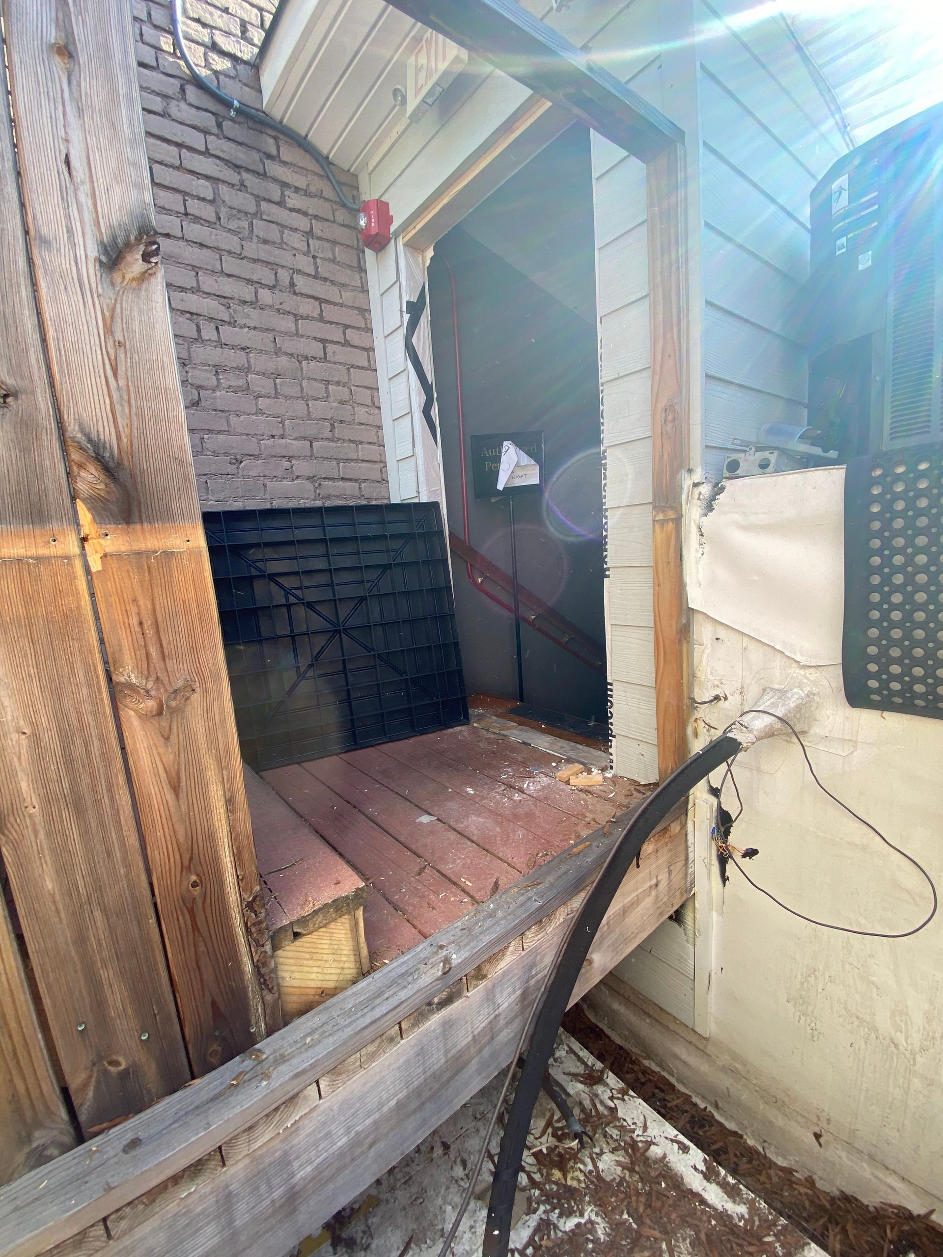 A wooden fence is surrounding a doorway in a house.