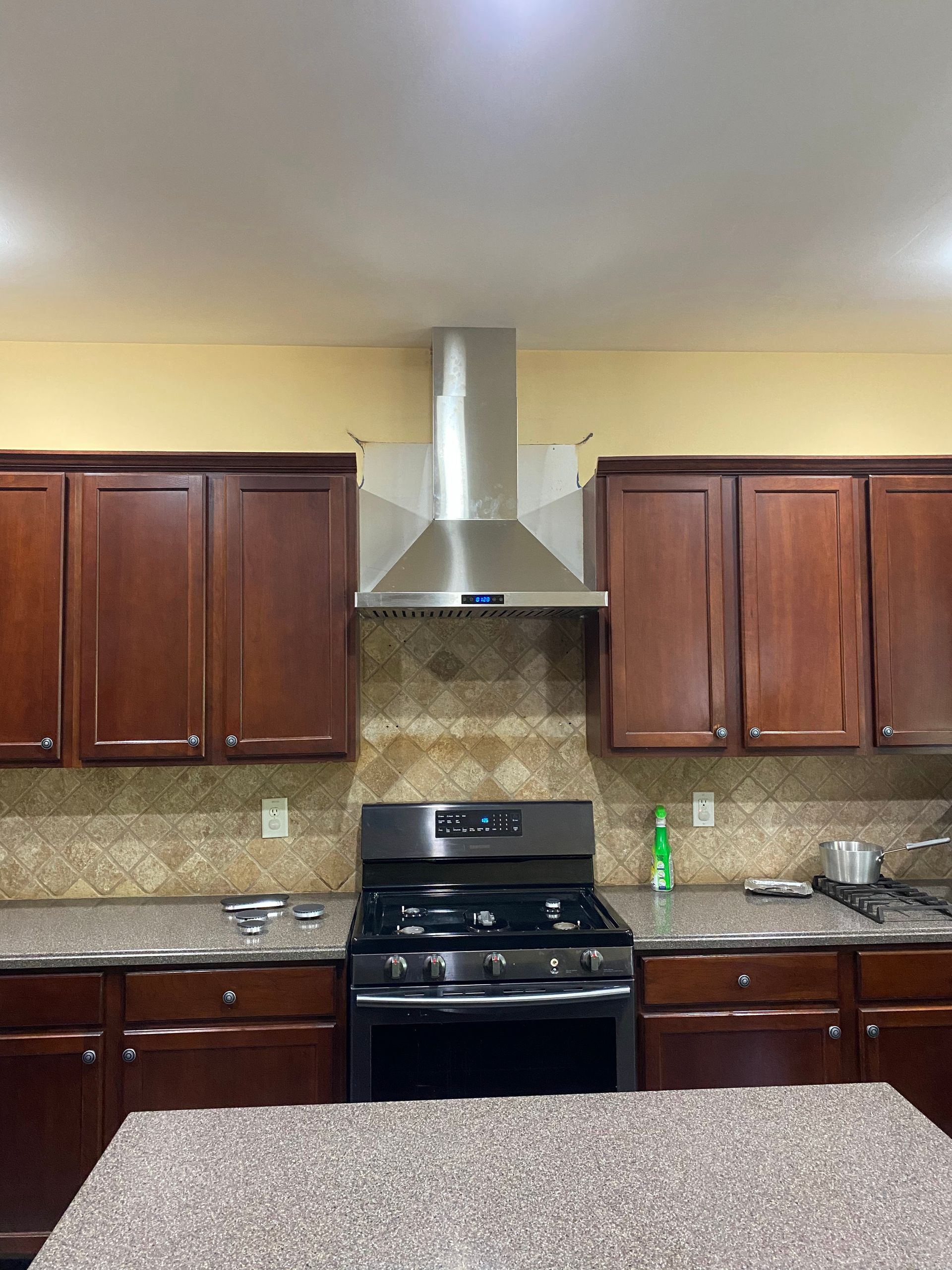 A kitchen with stainless steel appliances and wooden cabinets