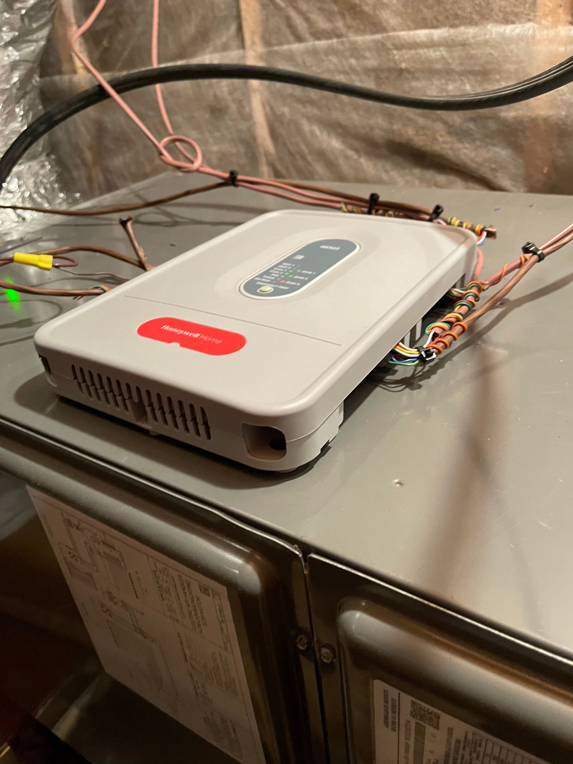 A white box with a red sticker on it is sitting on top of a stove.
