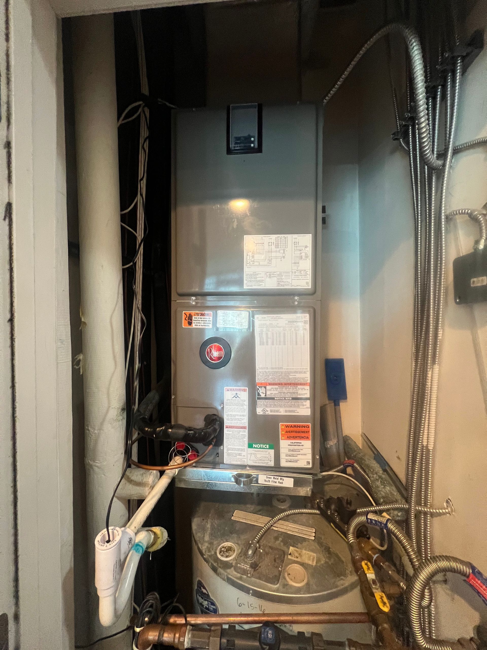 A heater is sitting in a room next to a wall.