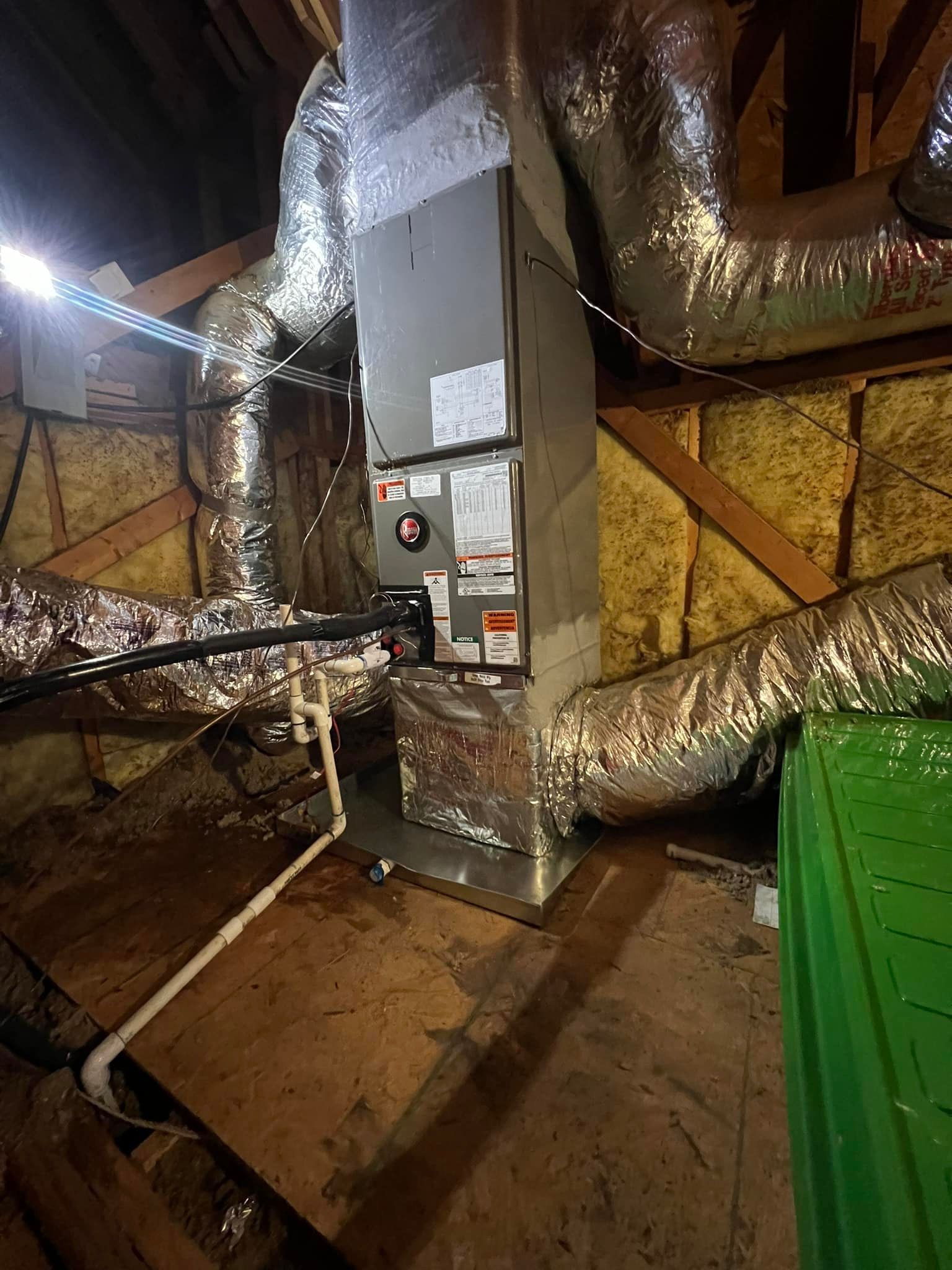 An air conditioner is installed in the attic of a house.