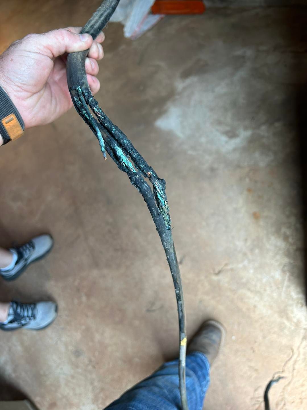 A person is holding a very long wire in their hand