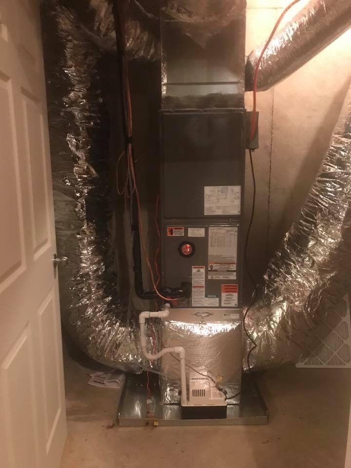A picture of an air conditioner in a basement.