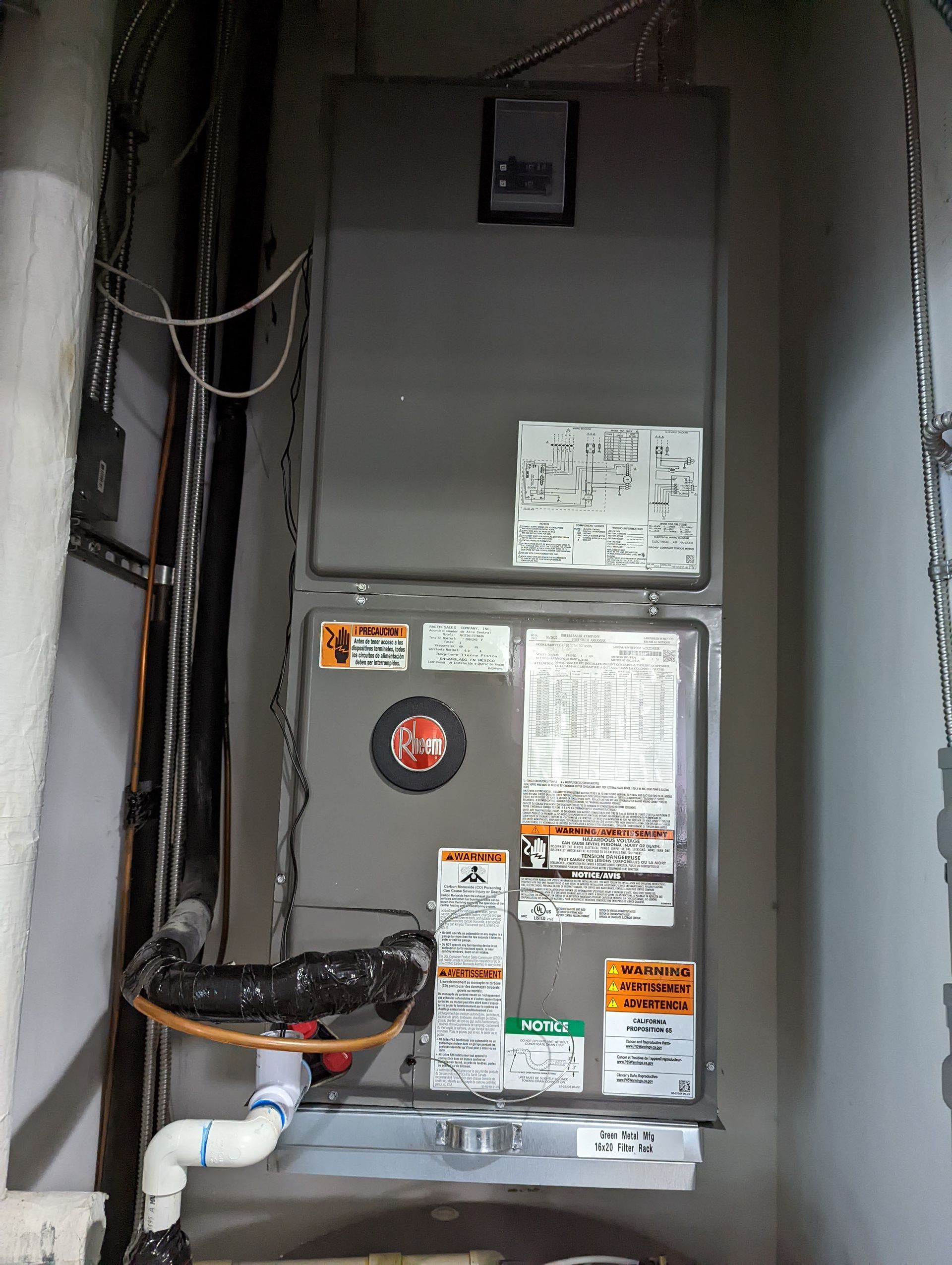 An air conditioner is hanging on a wall in a room.