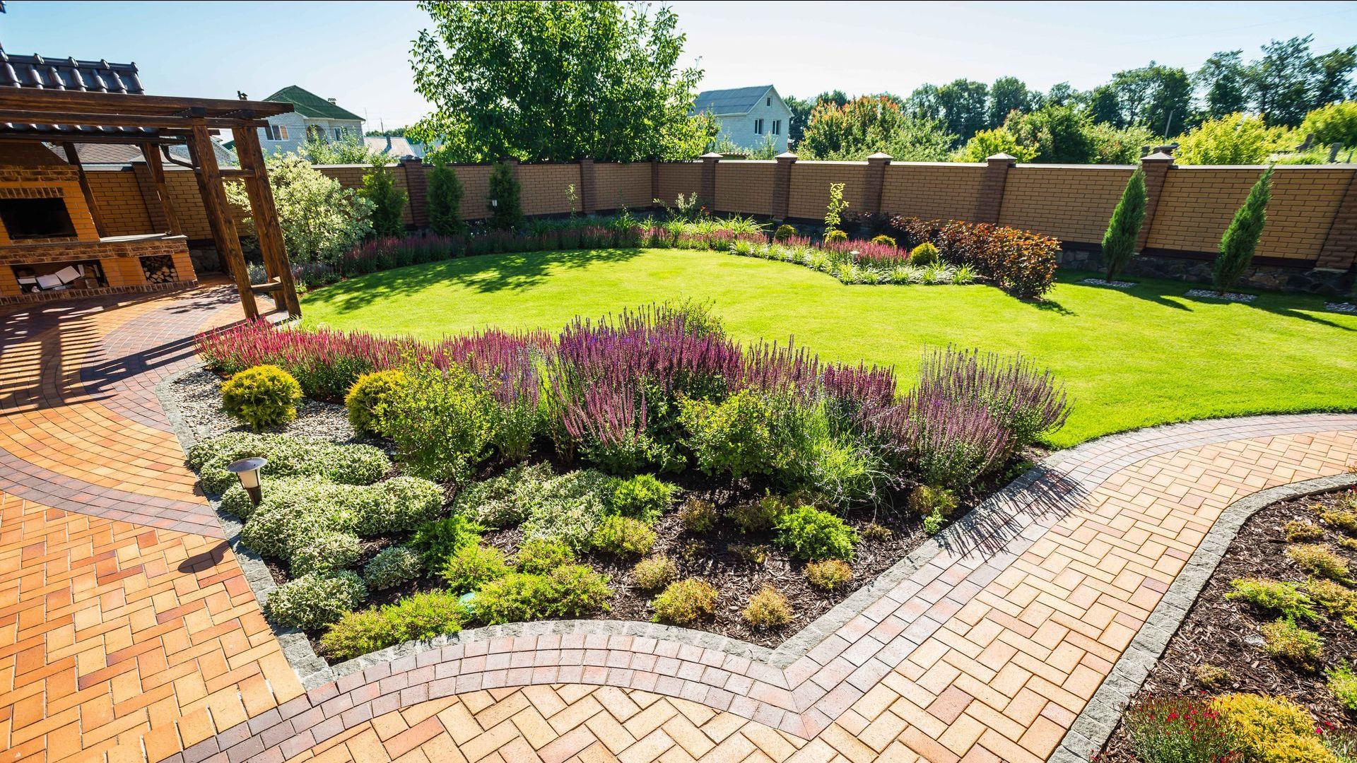 There is a brick walkway in the middle of the garden.